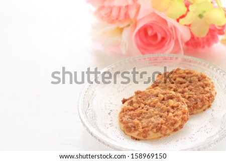 Home bakery, caramel and nut cookie with flower on background for gourmet dessert food image