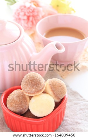 sugar donut and milk tea with flower for afternoon tea image