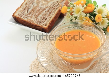 Summer gourmet, cold carrot soup and bread for gourmet breakfast image