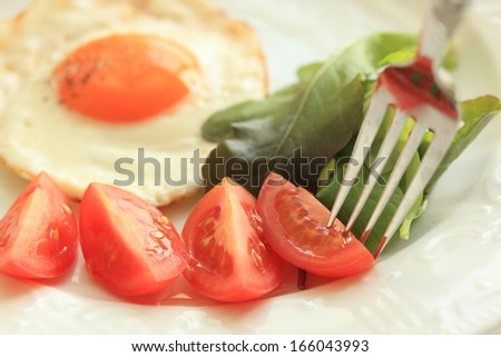 close up of chopped tomato with sunny side up on side for healthy breakfast image