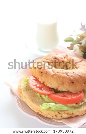 Vegetarian bagel sandwich and milk
