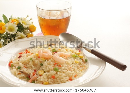French food, shrimp and paprika pilaf with iced tea on background