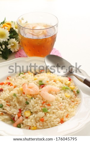 French food, shrimp and paprika pilaf with iced tea on background