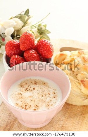 hot milk with cinnamon powder and bread for breakfast image