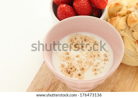 hot milk with cinnamon powder and bread for breakfast image