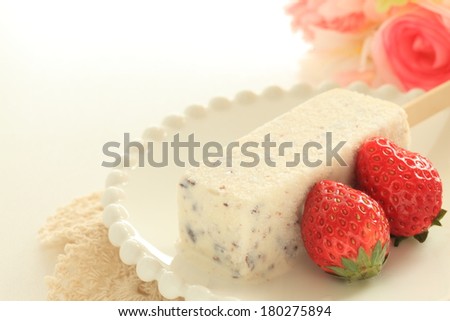 homemade Vanilla and chocolate chips ice bar with strawberry on side for kid menu image