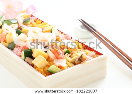 Japanese cuisine, Chirashizushi packed lunch bento with flower on background