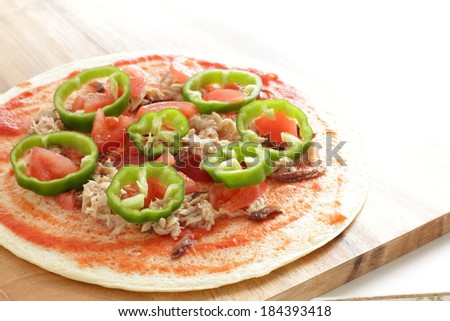 homemade pizza, tuna fish and green pepper on crust