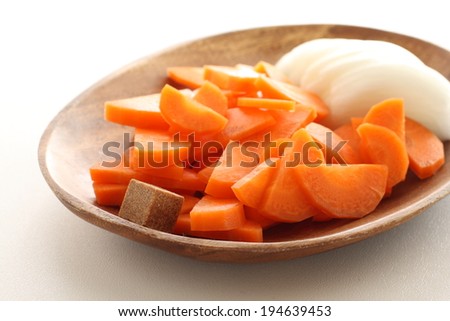 sliced carrot and onion with instant Bouillon cube for soup instant image