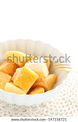 Frozen Mango on white bowl for gourmet food ingredient image