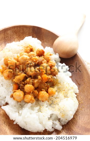 Chick pea curry and rice on wooden plate for cafe food image