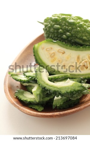 south east asian food ingredient, bitter melon chopped on wooden plate