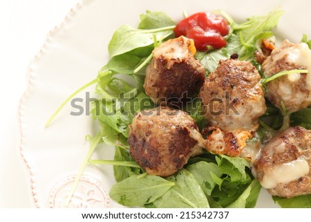 Homemade meat ball on baby leaf salad