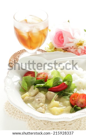 Thai cuisine,  chicken and coconut milk Green Curry with iced tea on background