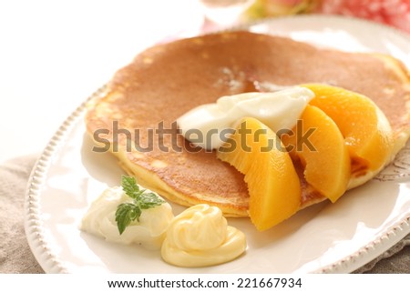 healthy pancake, peach and yogurt on top for breakfast image