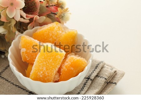tropical food, frozen apple mango on flower background