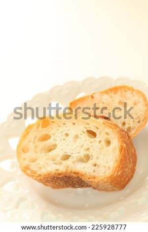 Frozen bread, baguette on dish with copy space for storage food image