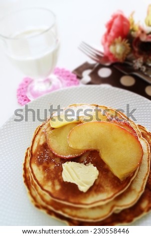 simmered caramel apple and butter on pan cake with glass of milk