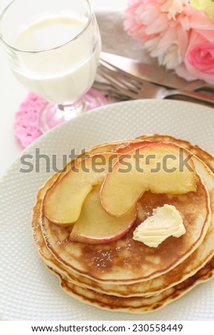 simmered caramel apple and butter on pan cake with glass of milk