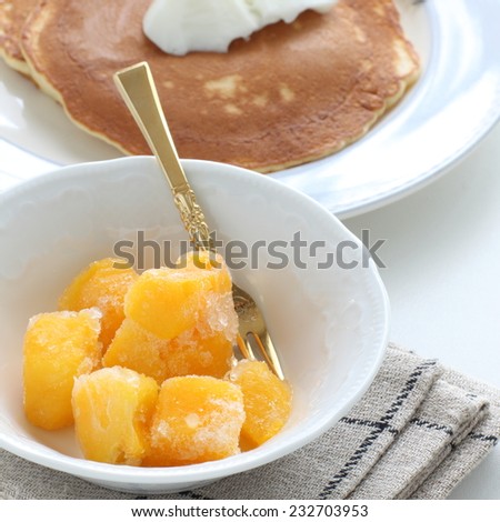 frozen mango with pancake on background