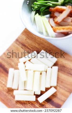 Korean food ingredient, sticky rice cake stick Garaeddeok with vegetable on background