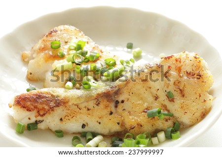 Chinese cuisine, fried cod fish with spring onion and soy sauce
