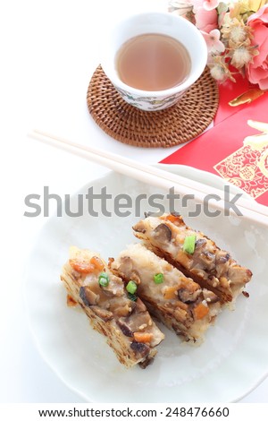 chinese new year food, turnip cake sliced and fried on dish for dim sum image