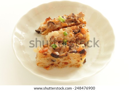 chinese new year food, turnip cake sliced and fried on dish for dim sum image