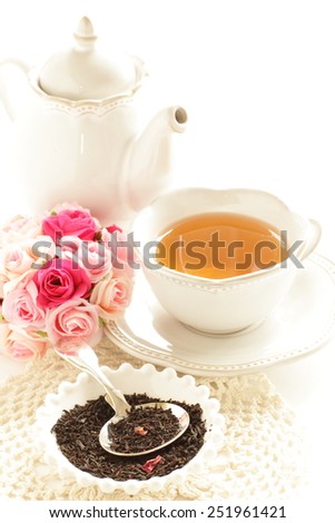 English tea, black tea leaves and rose