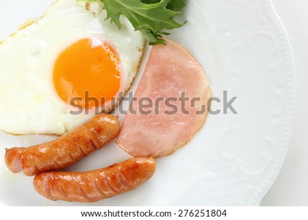 Sunny side up fried egg and sausage for gourmet homemade breakfast image