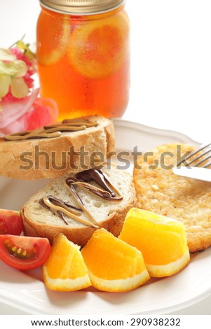 butter toast, hash brown and orange breakfast with jar tea on background for cafe food image