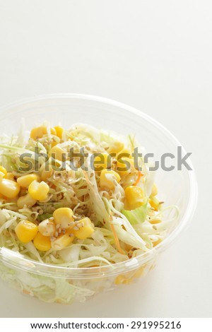 sweet corn and cabbage salad in food container for take out food image