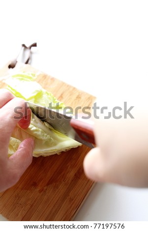 Chopping the celery on wooden chopping board