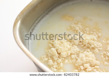 Chinese ingredient, almond powder and milk in pot for cooking the Almond tofu