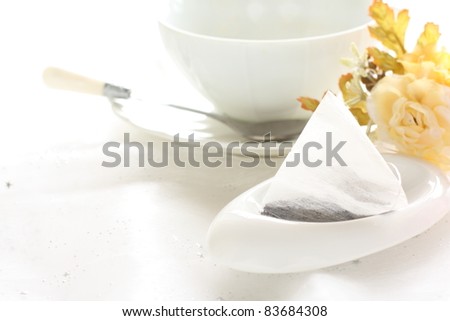 Tea bag on white background with flower and tea