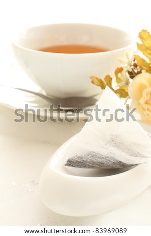Tea bag on white background with flower and tea