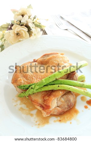 French cuisine, chicken sauteed with grilled asparagus and teriyaki sauce