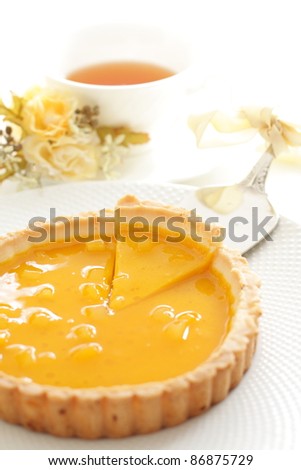 Mango tart with English tea and flower for afternoon tea image