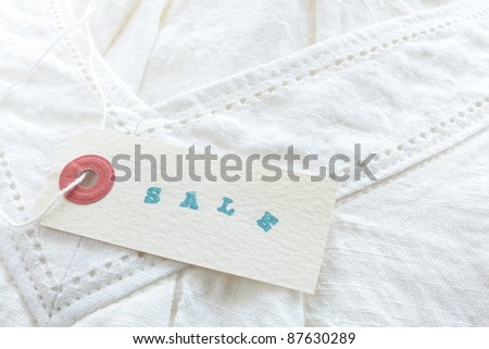 Paper tag on linen shirt for sale image