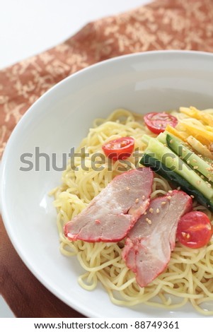 Chinese cuisine, summer cold noodles with vegetable and roasted pork