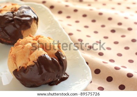 French confectionery, chocolate coating Eclair on dot cloth
