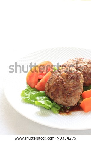 hamburger steak served with freshness tomato and boiled sweet carrot