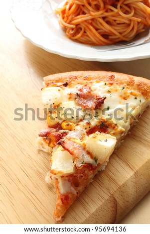 Italian cuisine, potato and bacon pizza and spaghetti