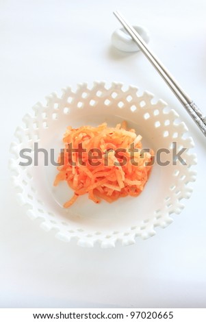 Korean food, pickled radish kimchi with silver chopsticks
