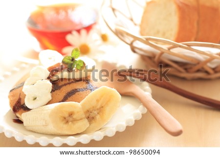 Banana and chocolate sauce pan cake with English tea for breakfast image