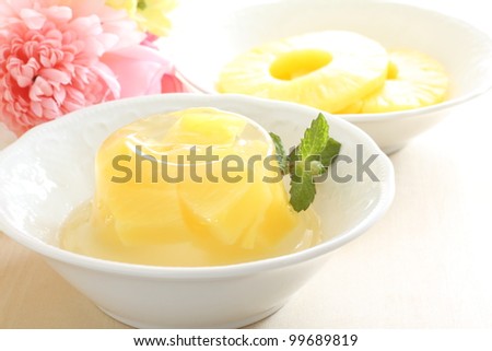 Gourmet dessert, pineapple and jelly with flower on background