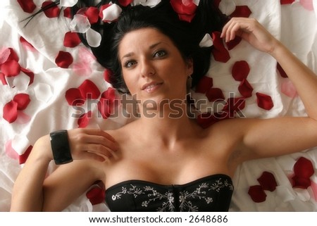 Woman laying on rose pedals
