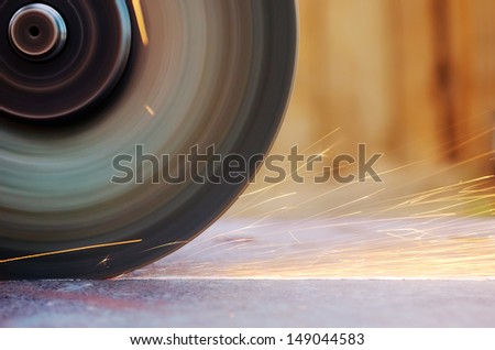 Closeup sparks from abrasive grinder circle