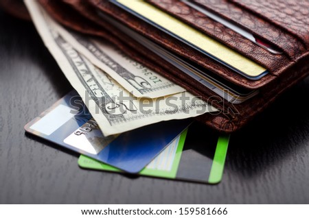 Plastic cards and american dollars in leather wallet