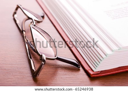 Glasses and the open book close up